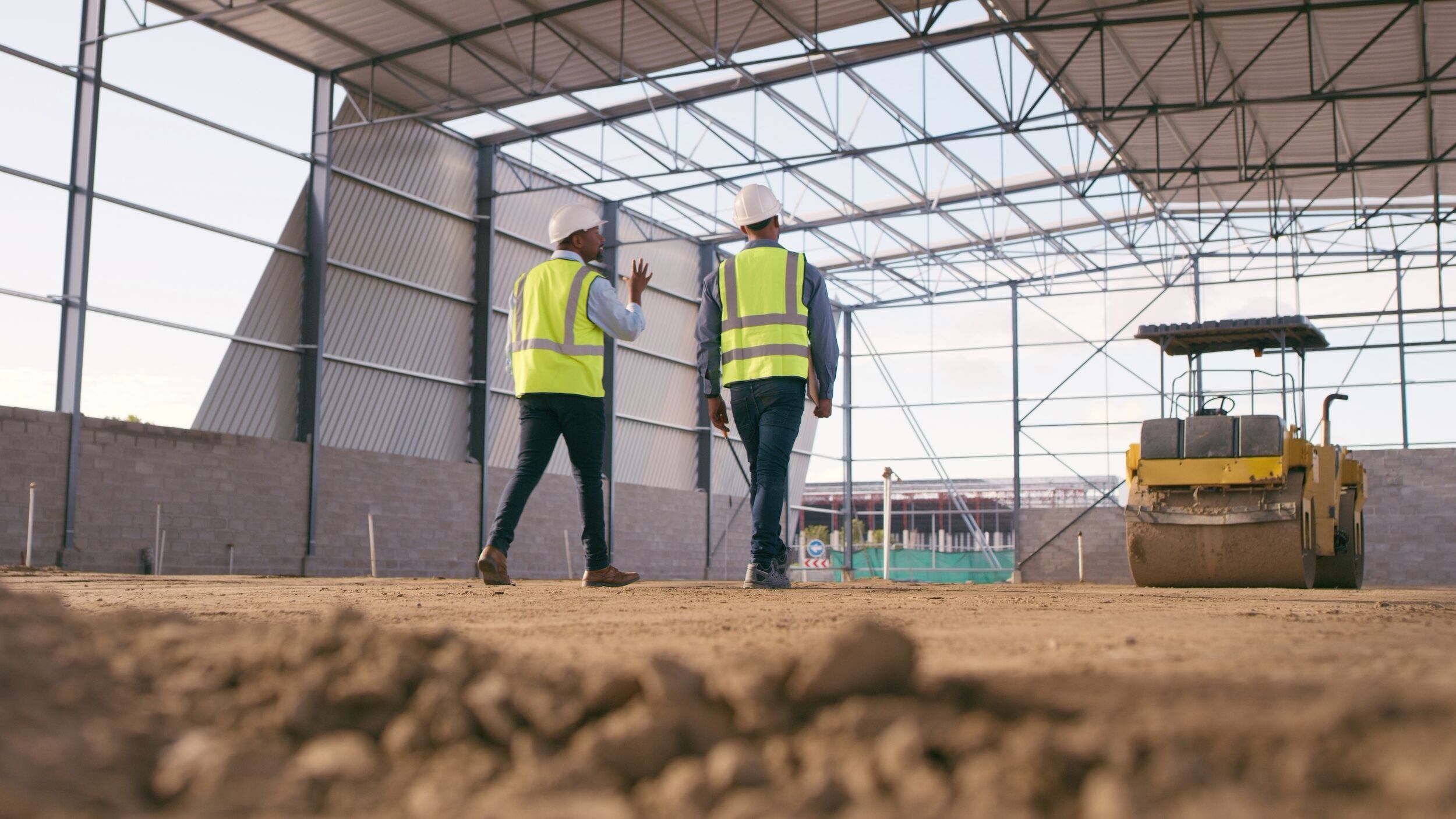  Contractor team walking through a warehouse.