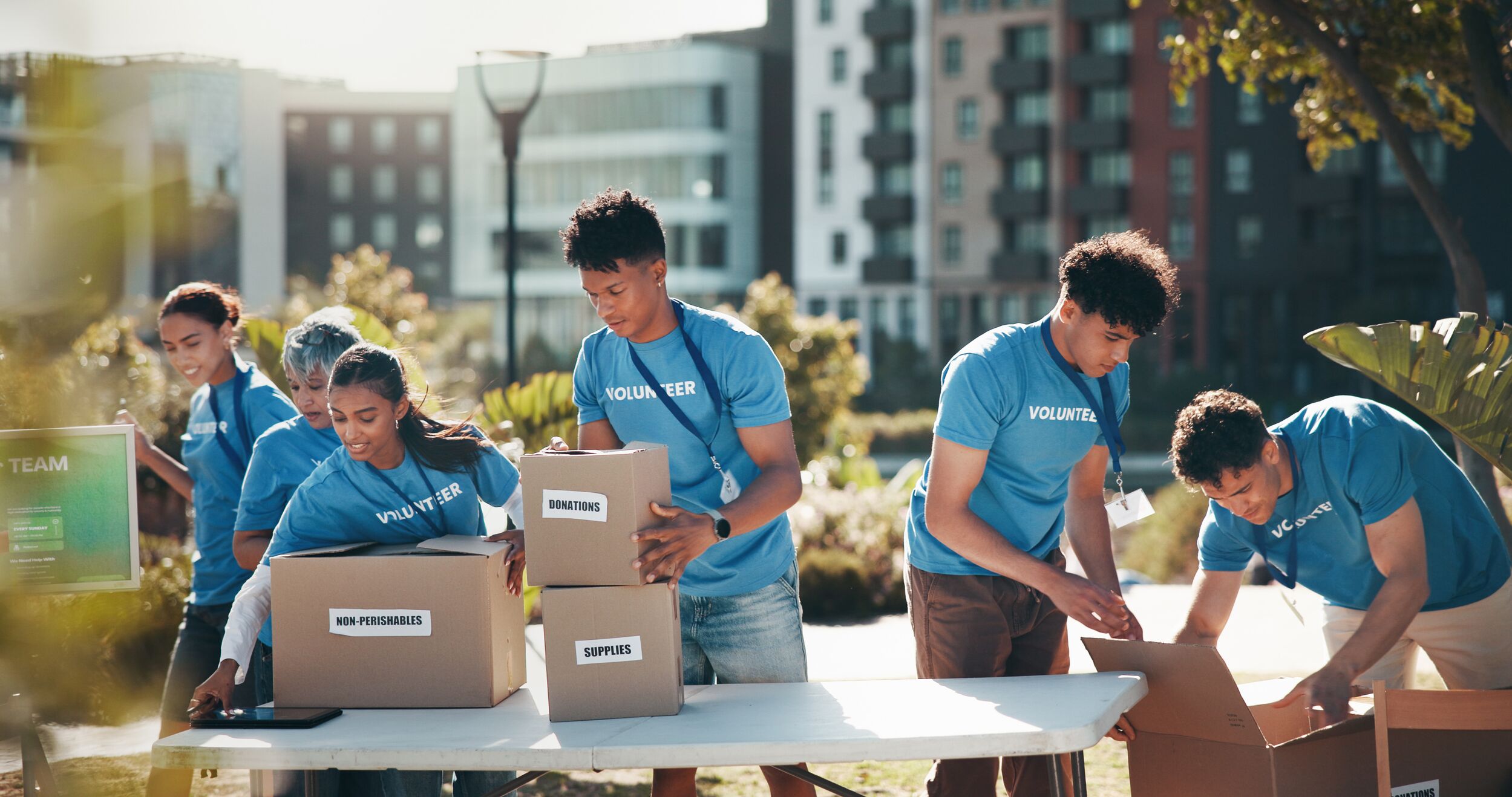 Group of volunteers at charity event in a park.