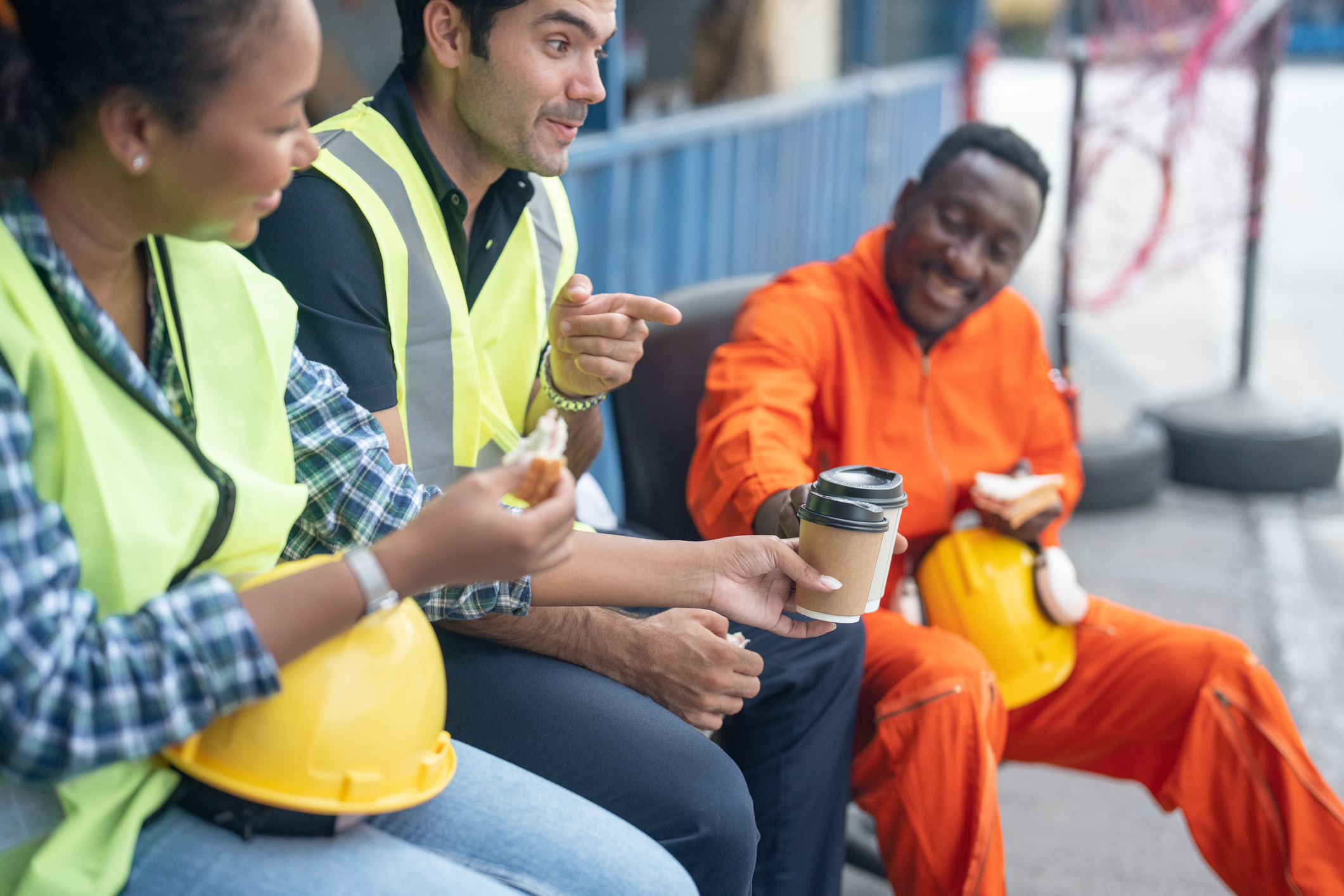 Group of construction workers on break talking and joking.