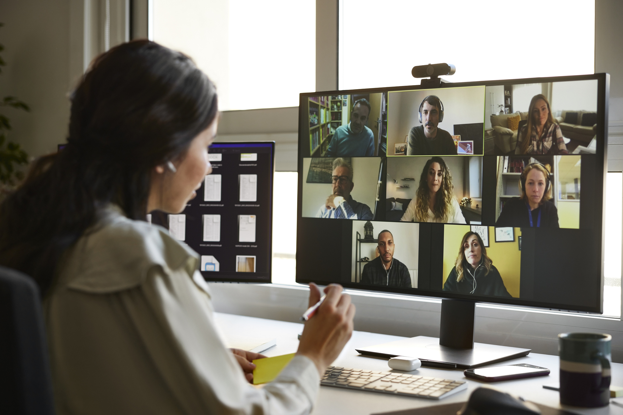 Woman sitting on a video conference call.
