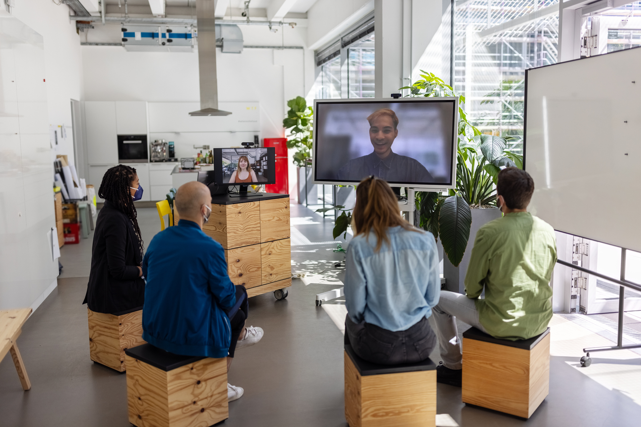 Group of coworkers sitting for a video presentation.