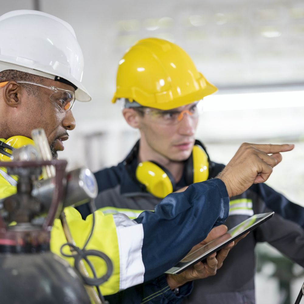 Manufacturing employees looking at tablet.