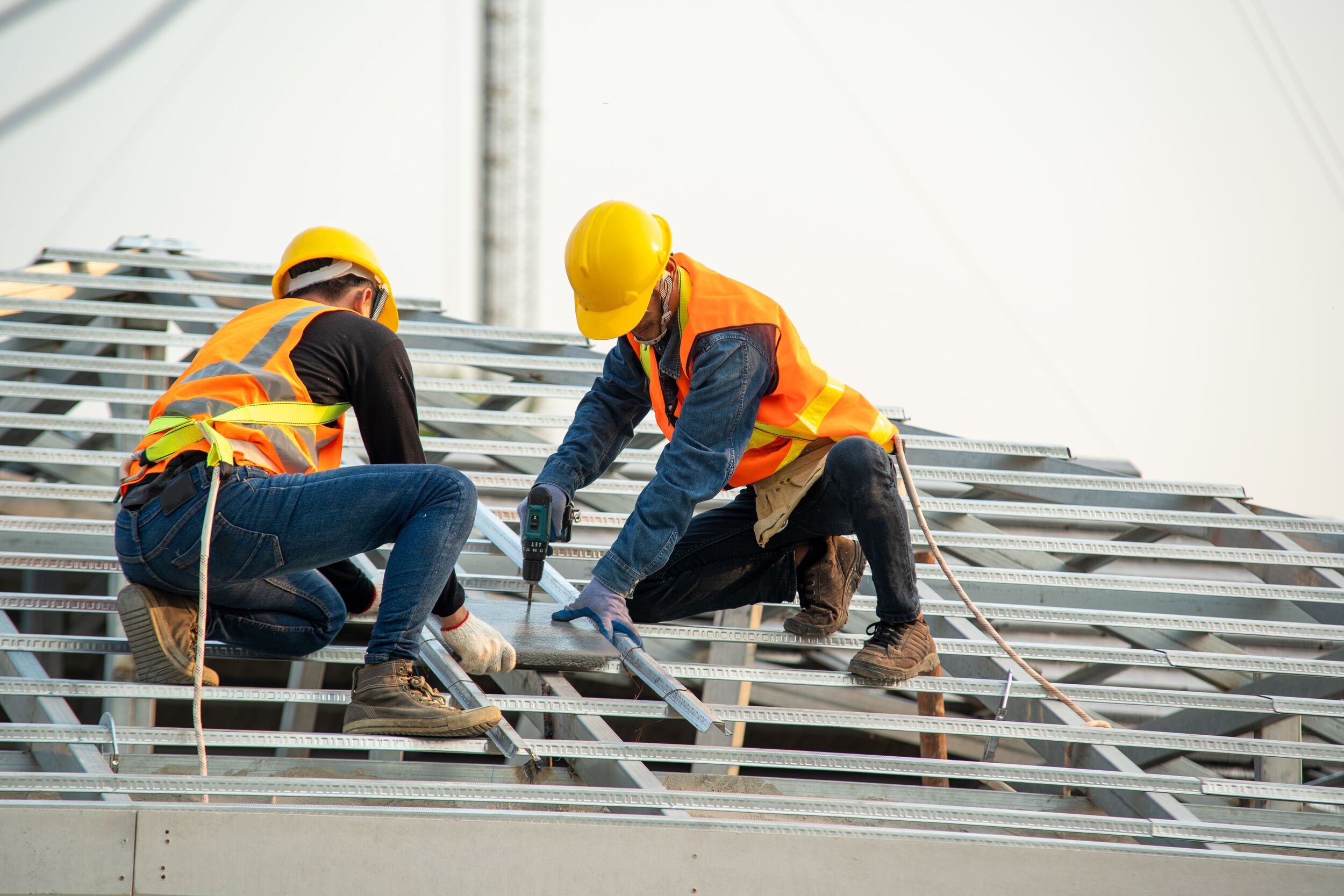 Roofer workers install new roof.